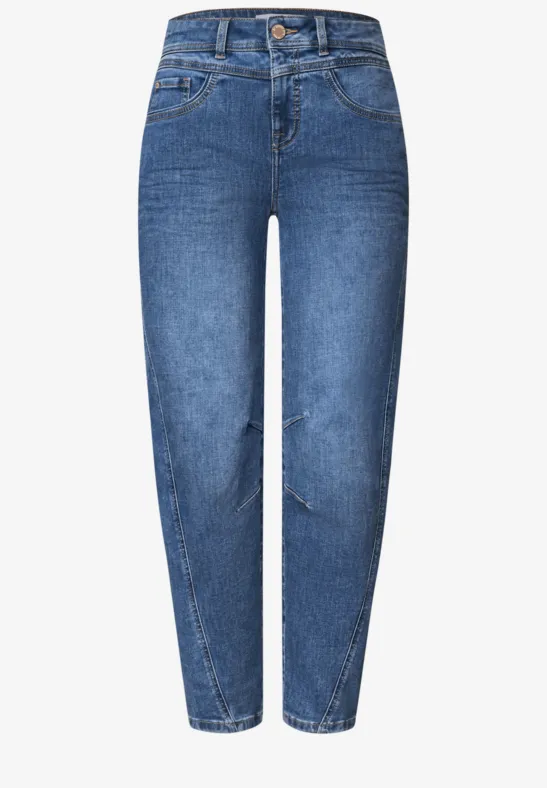 Ein Paar blaue Jeans mit hoher Taille, schmal zulaufenden Beinen und leichter Rissoptik.
