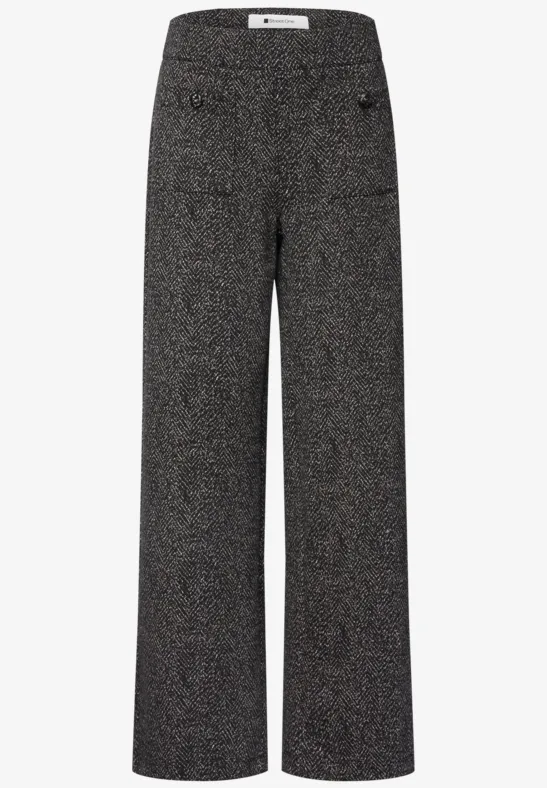 Weite, hoch taillierte Damenhose aus dunklem Tweed mit seitlichen Taschen.