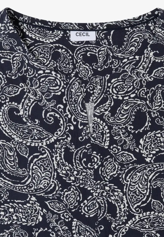 Haut sans manches bleu foncé à motif cachemire blanc avec petite fente sur l'encolure.