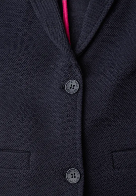 Veste bleu marine texturée, deux boutons et doublure intérieure rouge visible.
