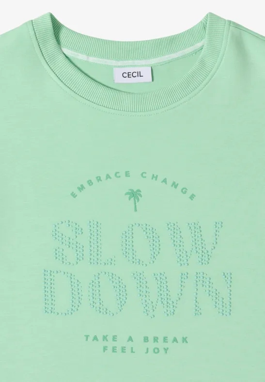 T-shirt vert menthe avec icône de palmier et inscriptions «Embrace Change», «Slow Down» et «Take a Break Feel Joy».