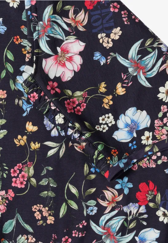 Schwarzer Stoff mit buntem Blumenmuster in Rosa, Gelb, Blau und Rot.