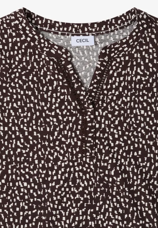Blouse marron à pois blancs, col en V avec patte de boutonnage, manches courtes.