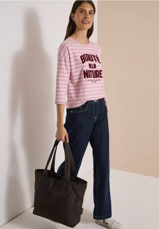 Femme en t-shirt rose rayé 'BONJOUR LA NATURE', jean ample et grand sac noir