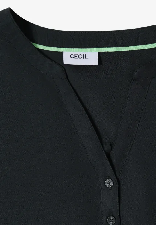 Schwarzes Oberteil mit V-Ausschnitt und sichtbar angebrachten 'CECIL'-Label.