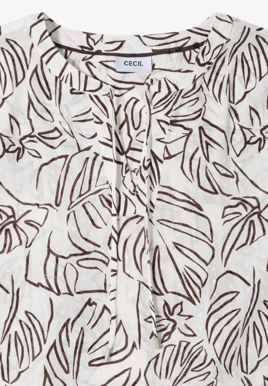 Blouse légère blanche en lin avec motif de feuilles marron, col en V à cordon et coupe décontractée.