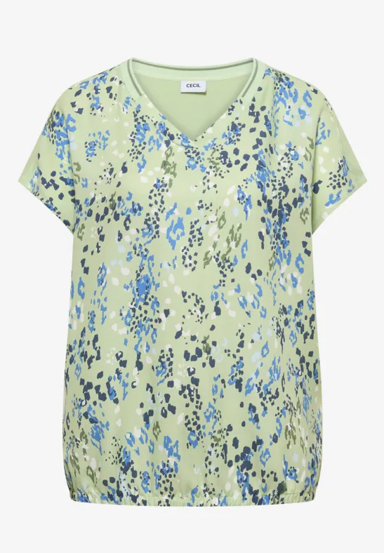 Blouse vert clair à motif floral abstrait bleu, col en V, manches courtes et ourlet élastiqué.