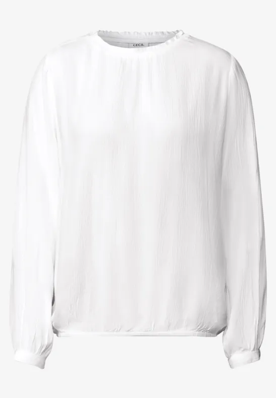 Weiße, langärmlige Bluse mit lockerem Schnitt.