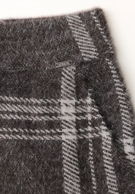 Gros plan d’un tissu en laine gris à motif écossais blanc et coutures