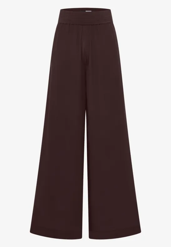Pantalon femme large taille haute de couleur brun foncé.