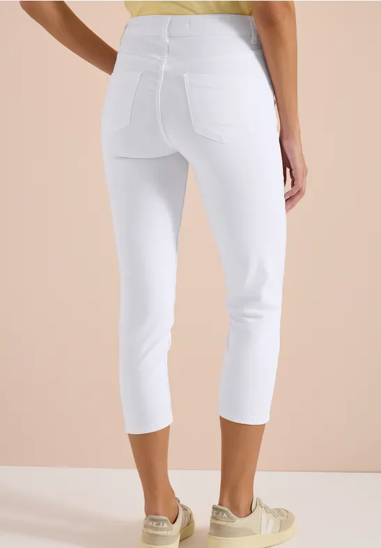 Eng anliegende, weiße Capri-Leggings mit hohem Bund und Gesäßtaschen, bis knapp unter die Knie.