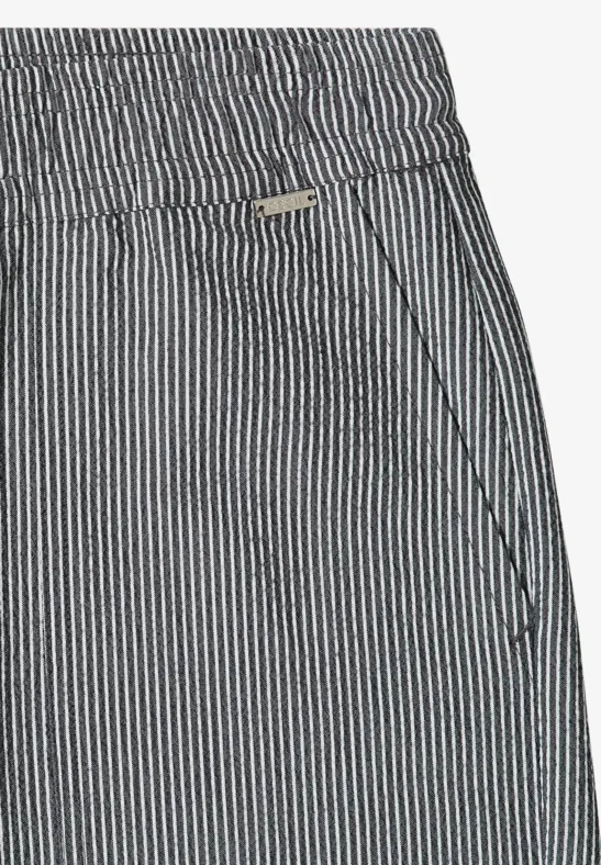 Hose mit elastischem Bund und seitlicher Tasche in blau-weiß gestreiftem Stoff.