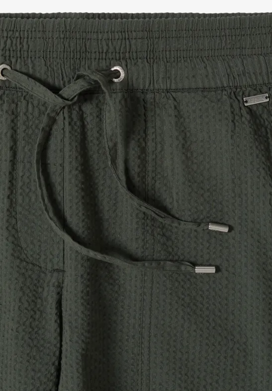 Dunkelgraue, waffle-strukturierte Hose mit elastischem Bund, Kordelzug und seitlichen Eingrifftaschen.