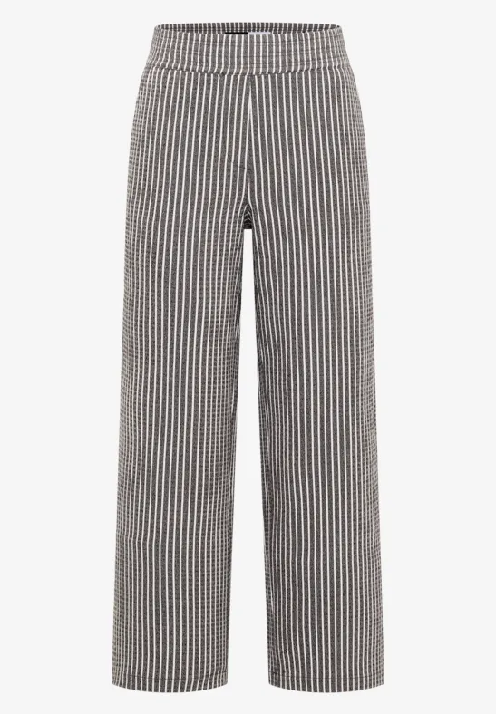Pantalon large à rayures verticales noir et blanc, taille haute.