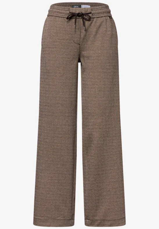 Pantalon ample marron à taille élastiquée avec cordon et motif discret, parfait pour un look détente.