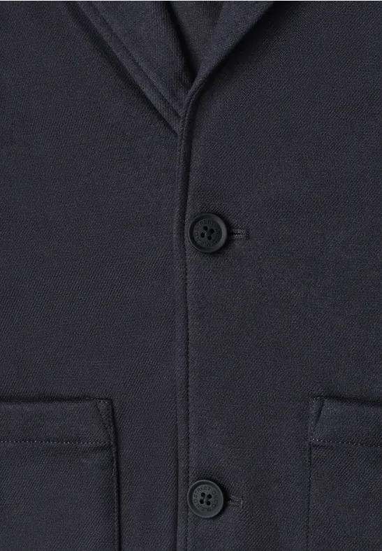 Dunkelblauer Wollmantel mit Knöpfen und aufgesetzten Taschen.