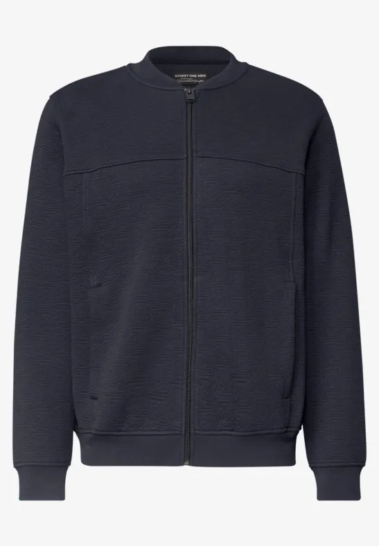 Blouson bomber bleu marine à fermeture éclair, poches latérales et finitions côtelées.