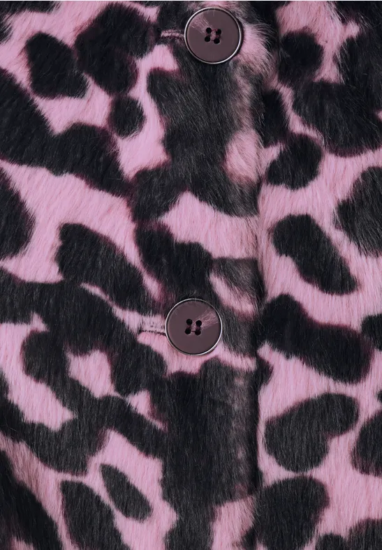 Nahaufnahme eines pink-schwarzen, gepunkteten Kunstpelz-Musters mit Knöpfen.