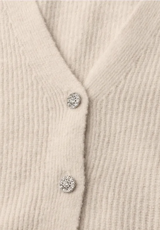 Beige gestricktes Cardigan mit glitzernden Strassknöpfen.