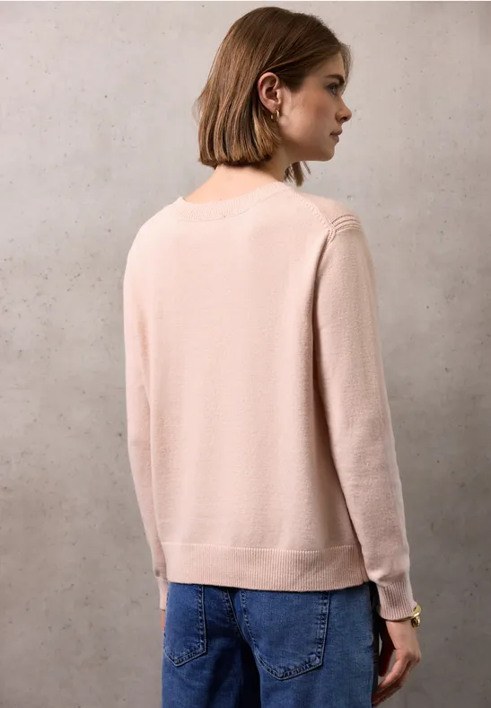 Pull doux avec détails peachy blush mel.