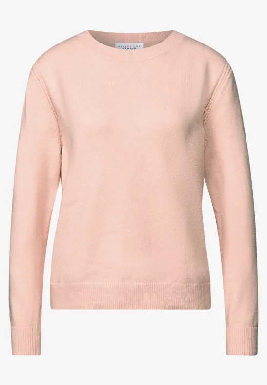 Pull doux avec détails peachy blush mel.