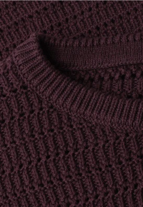 Nahaufnahme eines dunkelroten Strickpullovers mit Strukturmuster