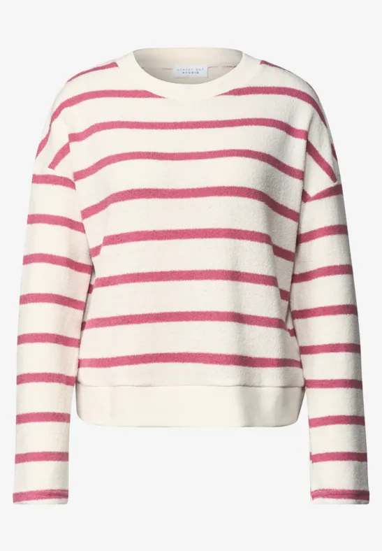 Ein weißer Pullover mit pinken Querstreifen und langen Ärmeln.