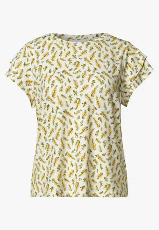 Wit T-shirt met korte mouwen en geel-groen bladpatroon.