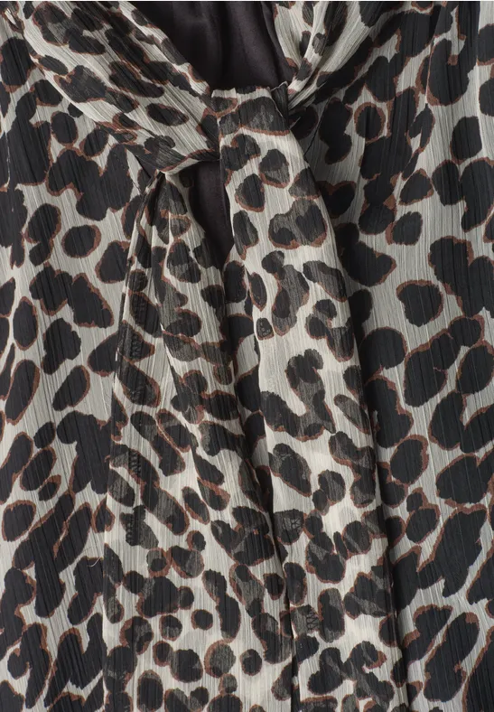 Tissu plissé imprimé léopard beige aux taches noires et brunes irrégulières
