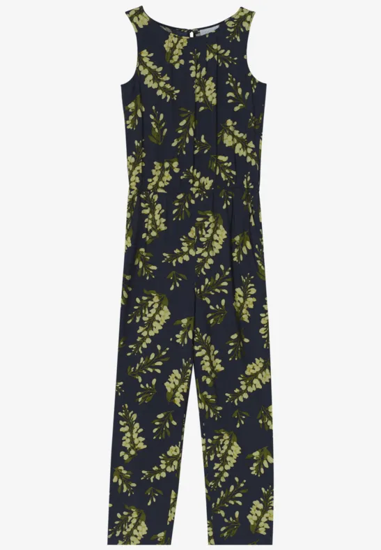 Ein ärmelloser, dunkelblauer Overall mit gelb-grünem Blätterprint.
