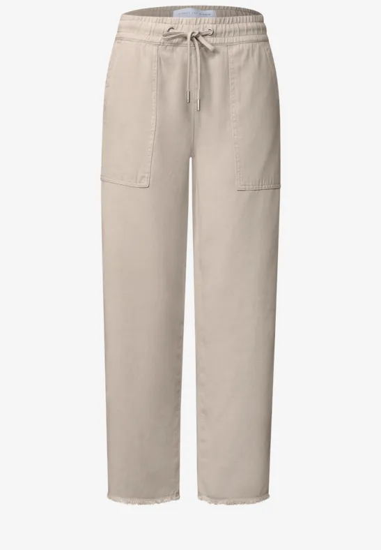 Beige vrijetijdsbroek met elastische taille, trekkoord, opgestikte zakken en rechte pijpen.