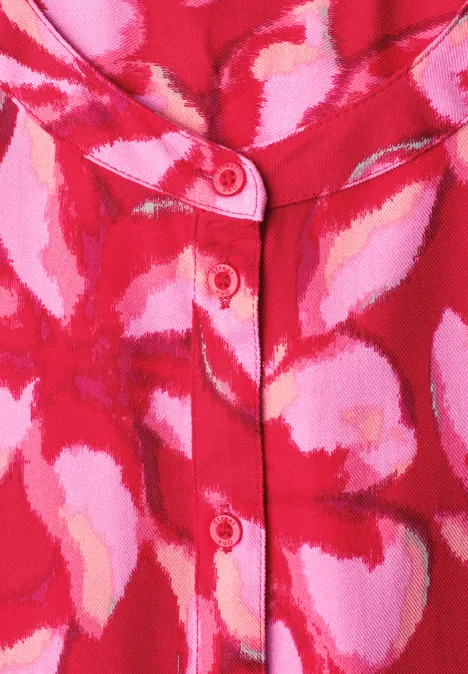 Chemisier rouge et rose à motif floral abstrait avec patte de boutonnage