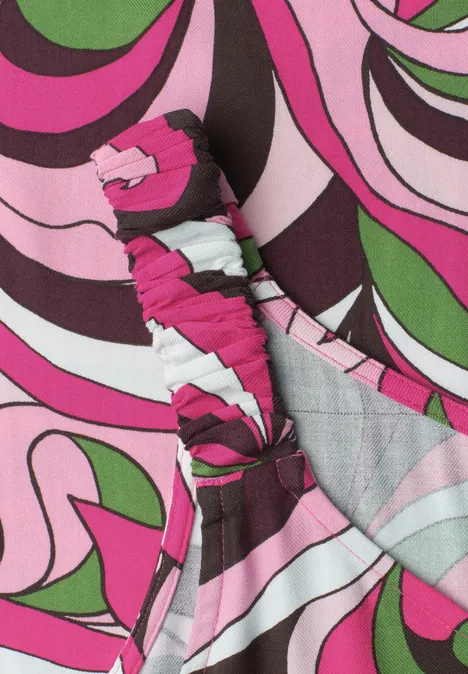 Un bandeau en tissu à motif psychédélique rose, vert, noir et blanc.