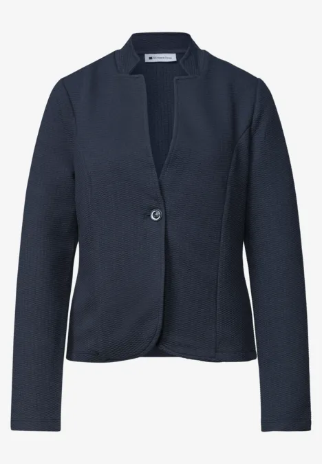 Blazer féminin bleu marine cintré, simple boutonnage à un bouton, col à revers épuré.