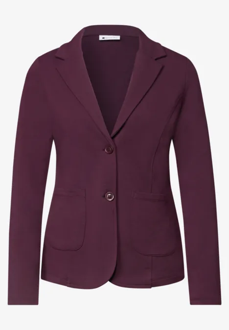 Damenblazer in dunklem Purpur mit zwei Knöpfen und aufgesetzten Taschen.