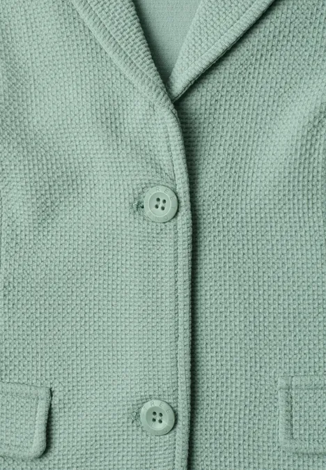 Mintgrüner, texturierter Blazer mit Reverskragen, zwei Knöpfen und aufgesetzten Taschen.