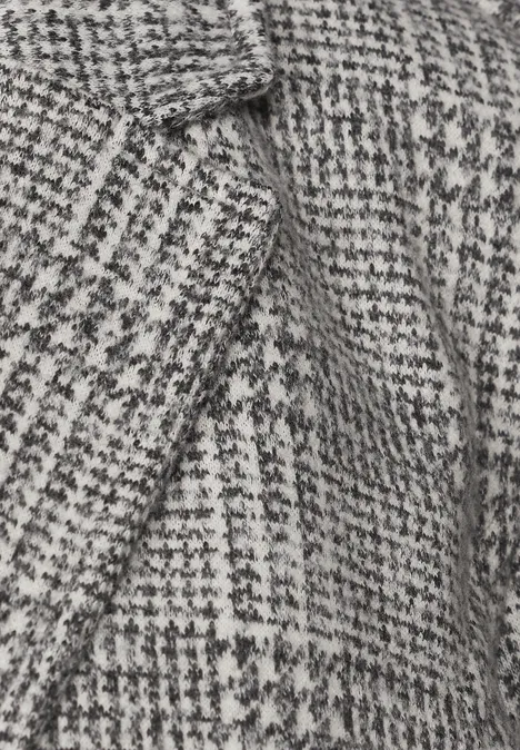Blazer à carreaux et boutons Black Nahaufnahme eines schwarz-weißen Hahnentrittmusters auf Wollstoff.