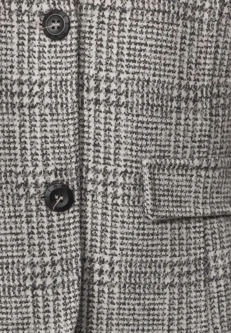 Blazer à carreaux et boutons Black Nahaufnahme eines grauen Hahnentrittmusters mit schwarzem Knopf und aufgesetzter Tasche.