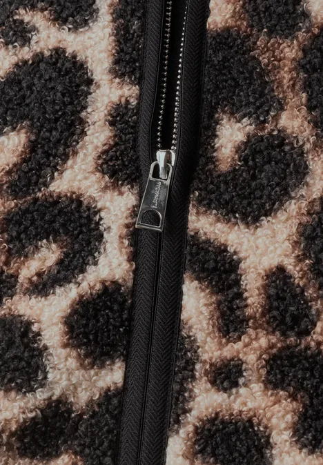 Gilet en peluche à fermeture zip et détails en velours côtelé Black Nahaufnahme eines Leopardenmusters mit schwarzem Reißverschluss auf flauschigem Stoff.