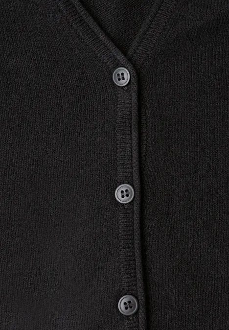 Nahaufnahme eines schwarzen, geknöpften Cardigans.