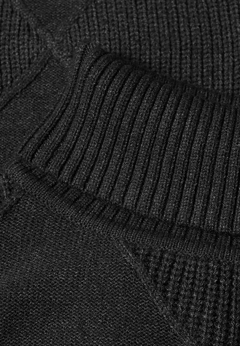 Nahaufnahme von geripptem, schwarzem Strickstoff.
