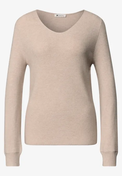Pull beige à manches longues avec encolure ronde dégagée.