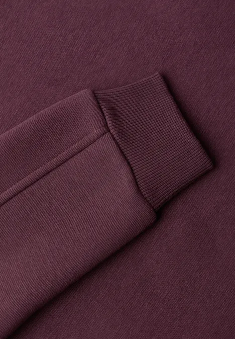 Sweatshirt mit Rundhals und Zierdetail rustic rouge Nahaufnahme eines burgunderfarbenen Sweatshirt-Ärmels mit Rippenbündchen.