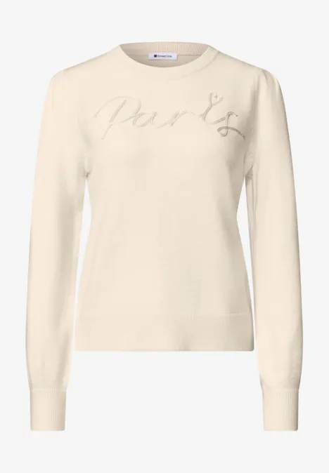 Pull crème à col rond, manches longues et broderie discrète en lettres sur la poitrine