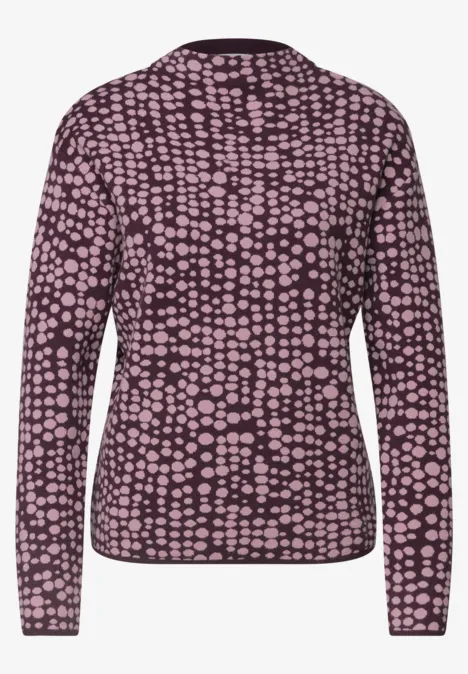 Dunkelvioletter Pullover mit langem Arm und hellrosa Tupfenmuster.