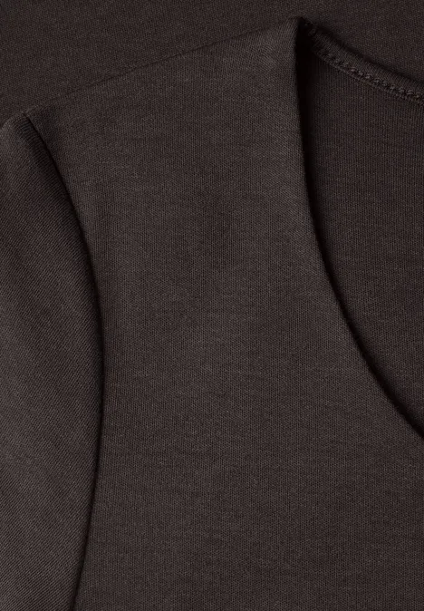 Nahaufnahme eines braunen T-Shirts mit sichtbarer Naht und rundem Ausschnitt.