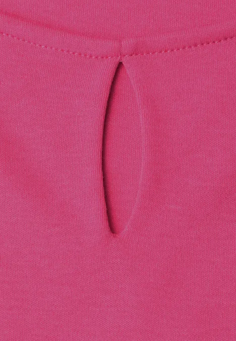 Nahaufnahme eines pinken Stoffes mit kleinem Tropfenausschnitt am Kragen