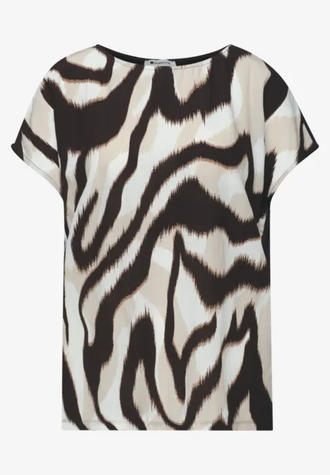 Losvallende korte mouw blouse met abstract zebra dessin in zwart en wit.