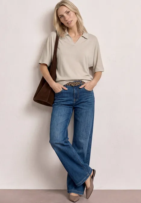 Poloshirt met elastische tailleband clay sand Persoon draagt een grijs poloshirt, blauwe jeans, een bruine schoudertas en loafers tegen een neutrale achtergrond.