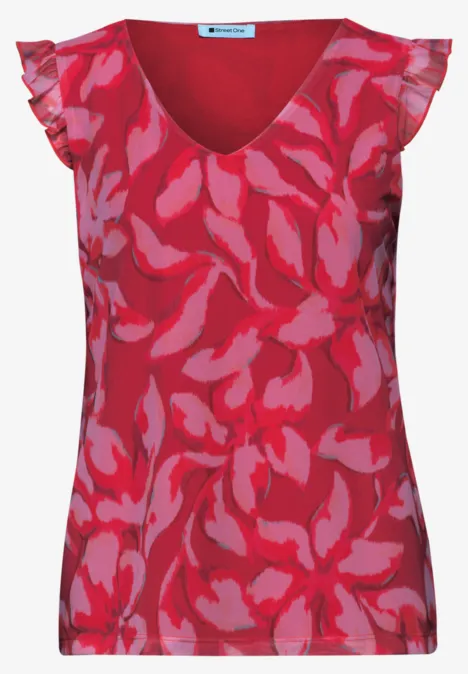 Rotes ärmelloses Top mit pinkem Blumenmuster und Rüschen an den Schultern.